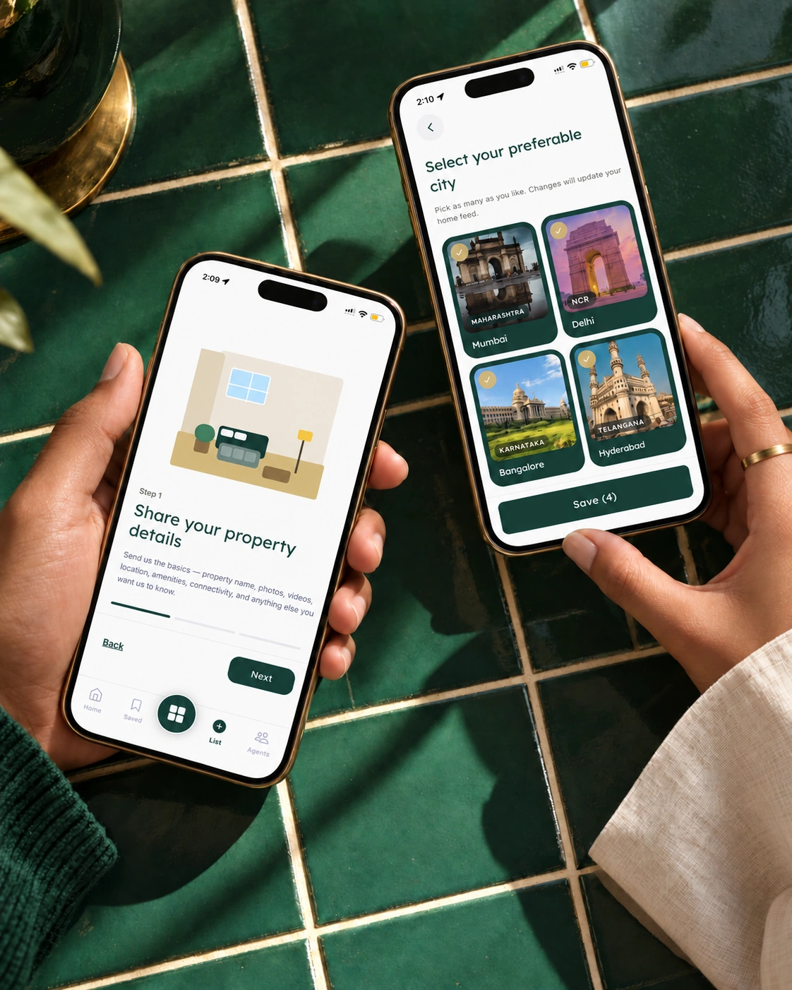 Two hands, each holding one phone, showing the 27 Estates property-listing and city-selection screens over emerald tiles